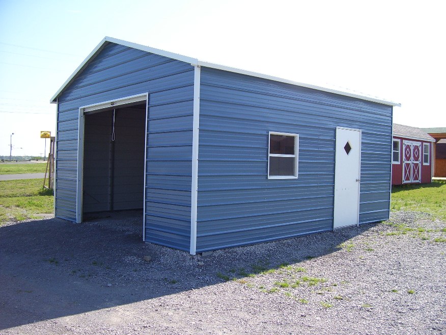 deluxe-one-car-steel-garage Deluxe one car steel garage with roll up garage doors and one walk in door.